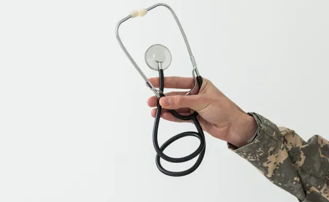 Young man army soldier holding stethoscope